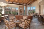 There is a dining room table that seats 8 guests and extra seating areas